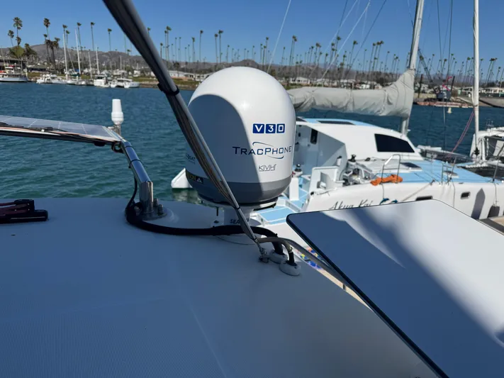  Yacht Photos Pics Lagoon 450 F 2017 yacht with TracPhone V3 antenna in a marina setting.