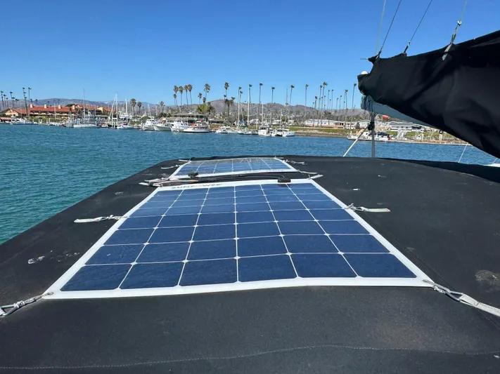  Yacht Photos Pics 2017 Lagoon 450 F catamaran with solar panels on deck, docked in a marina.