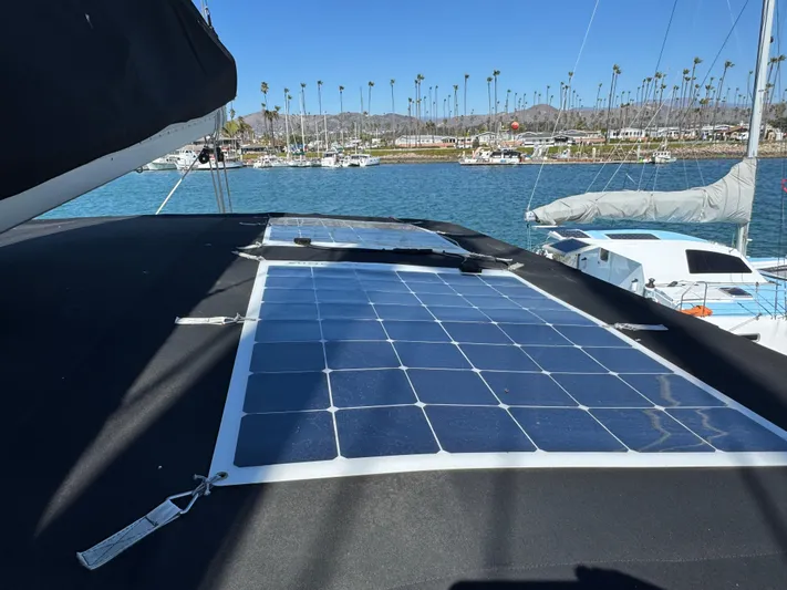  Yacht Photos Pics Solar panels on a 2017 Lagoon 450 F catamaran, docked in a marina with palm trees.