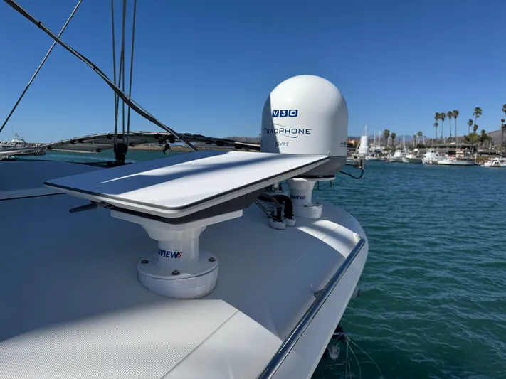  Yacht Photos Pics Lagoon 450 F 2017 yacht with satellite equipment on deck, docked in a marina.