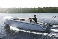 2024 Rand Picnic 18 boat cruising on a serene lake with lush forest backdrop.