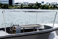 2024 Rand Picnic 18 boat on water, featuring a sleek design and canopy.