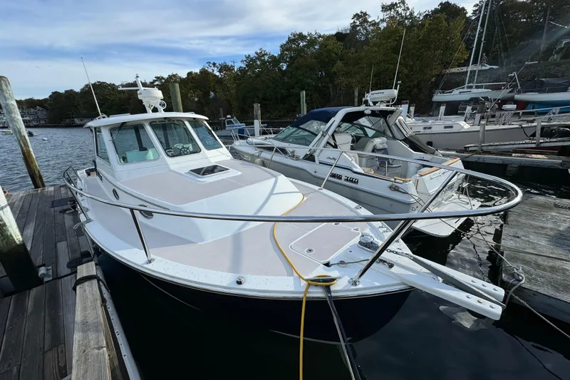  Yacht Photos Pics 2006 BackCove 29 boat docked at marina, surrounded by other vessels.