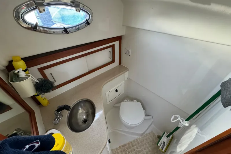  Yacht Photos Pics 2006 BackCove 29 boat bathroom with sink, toilet, and storage cabinets.