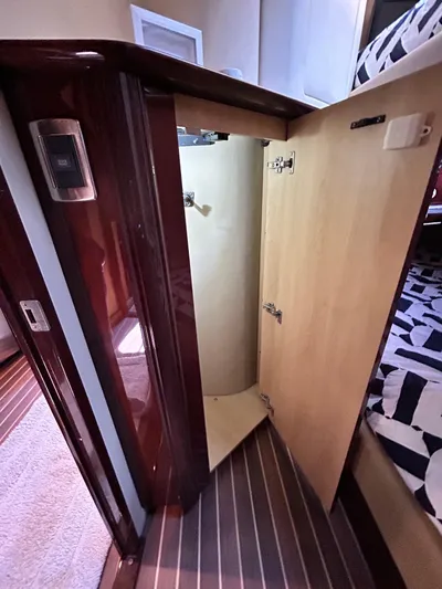  Yacht Photos Pics Open cabinet in 2007 Sea Ray 52 Sundancer yacht interior, showcasing wood finish and modern design.