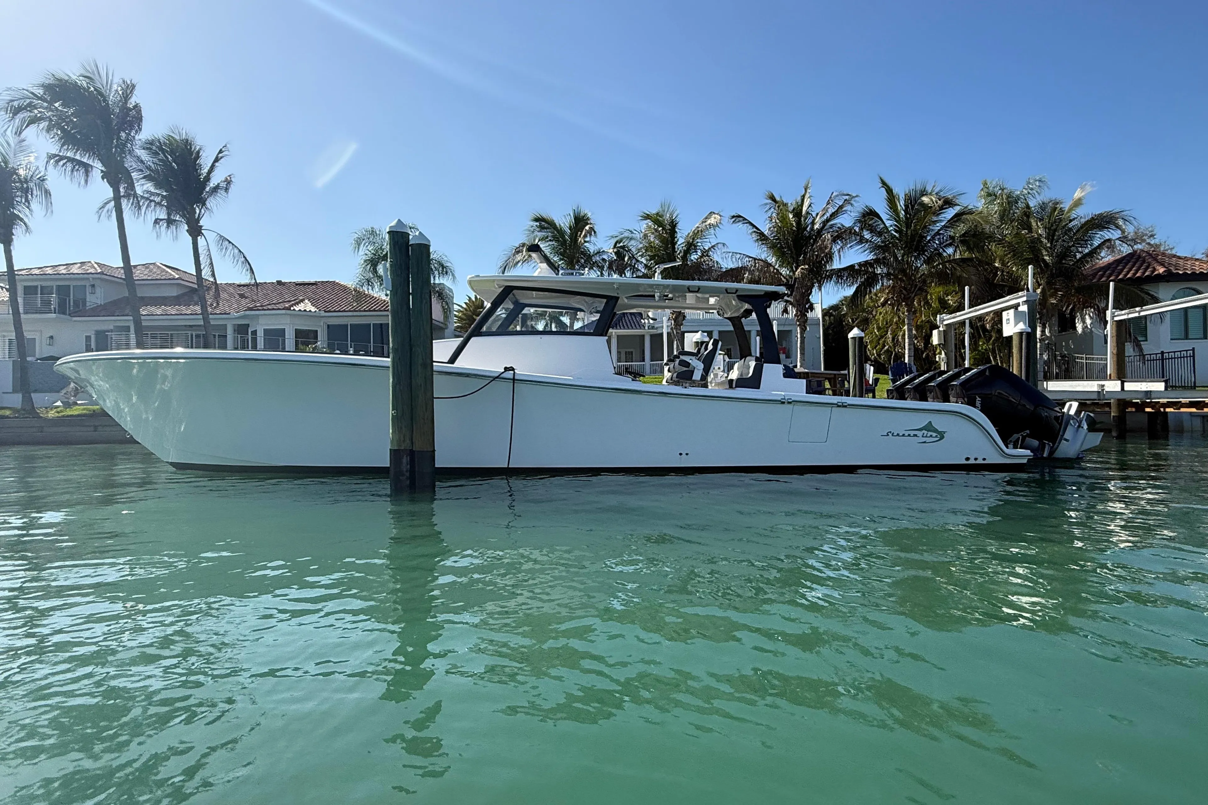 2020 Streamline 45 boat docked in sunny waterfront setting with palm trees.