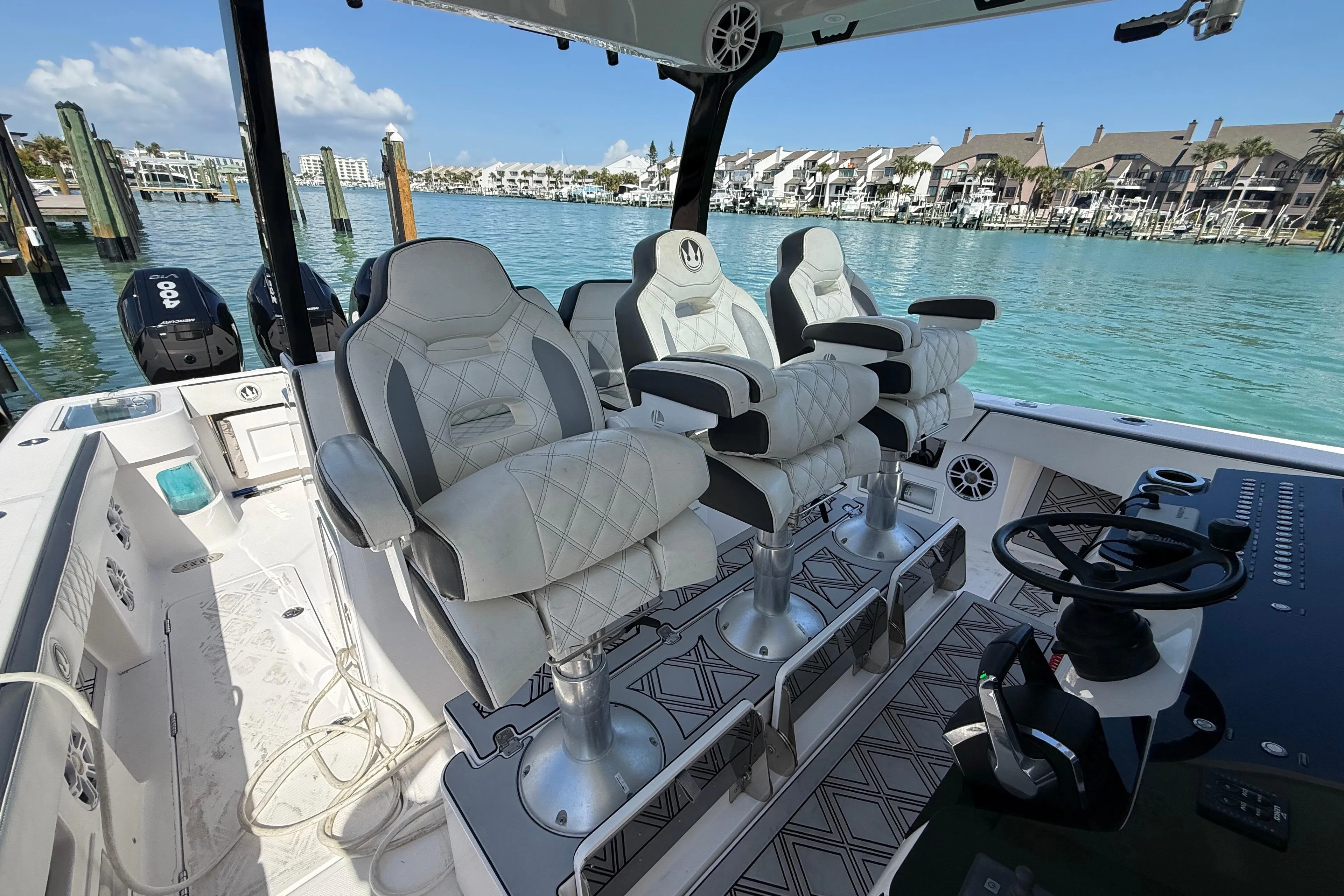 Luxury seating on a 2020 Streamline 45 boat, docked by waterfront homes.