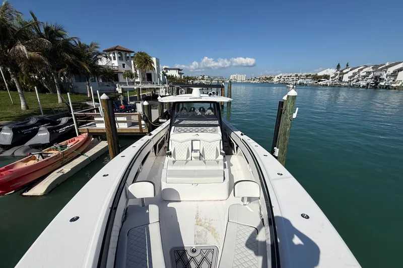  Yacht Photos Pics Streamline 45 boat docked in a scenic marina, surrounded by palm trees and waterfront homes.