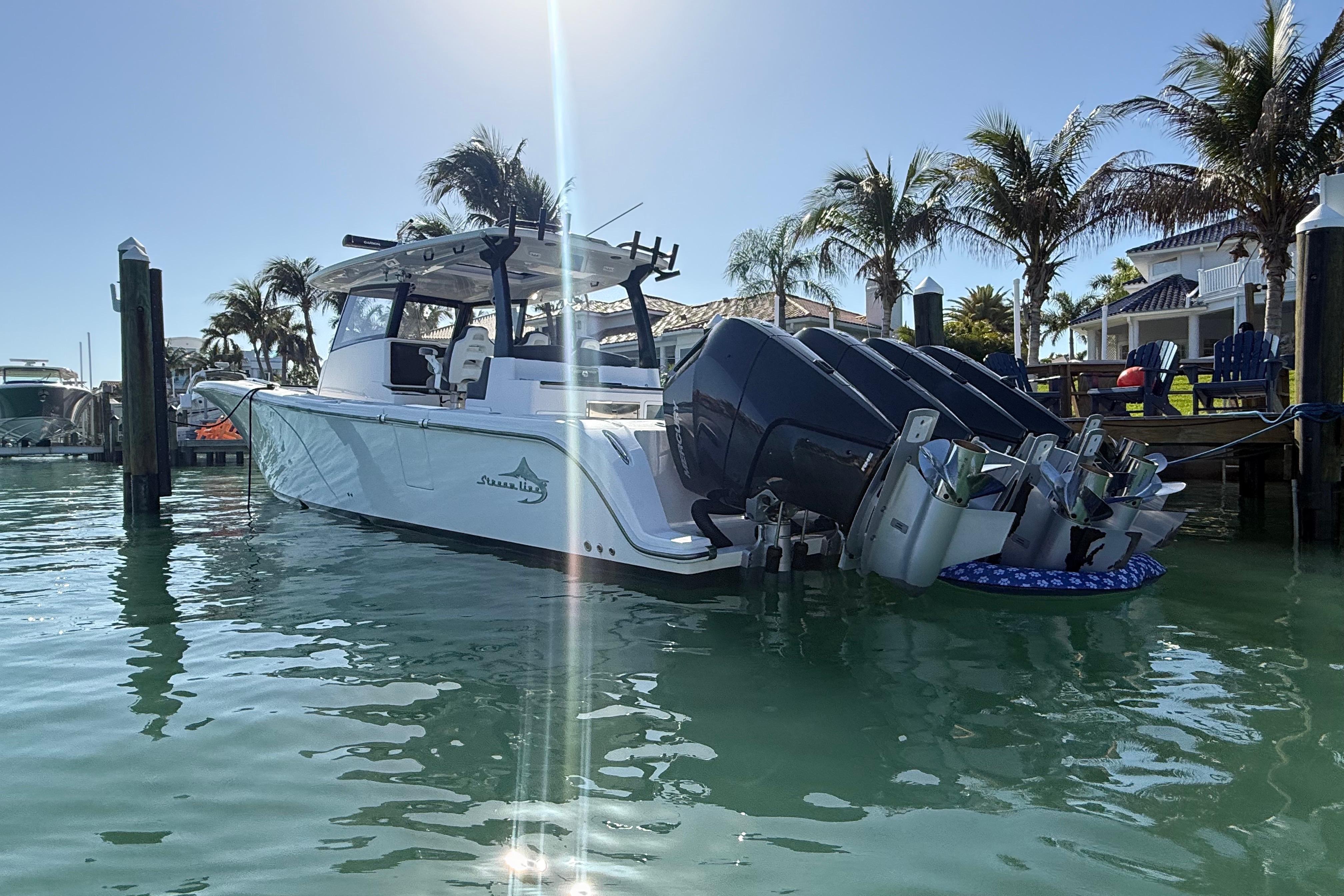 Streamline 45 boat docked in sunny marina, surrounded by palm trees, 2020 model.