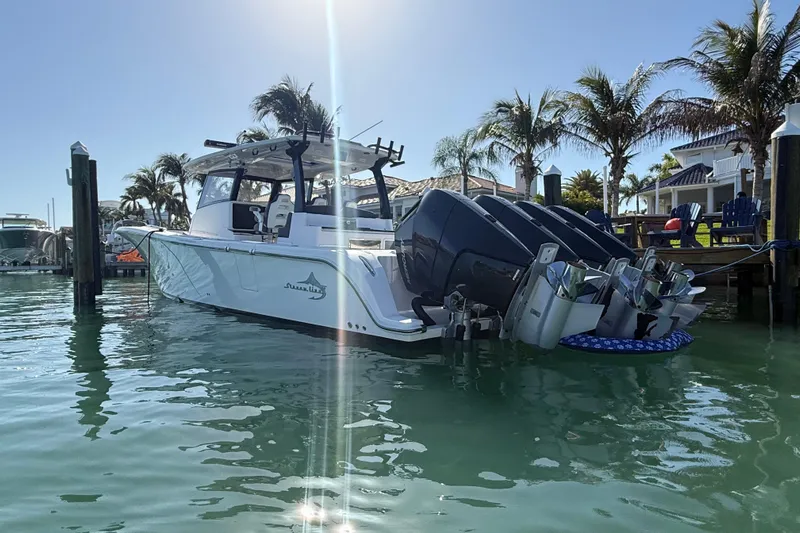  Yacht Photos Pics Streamline 45 boat docked in sunny marina, surrounded by palm trees, 2020 model.