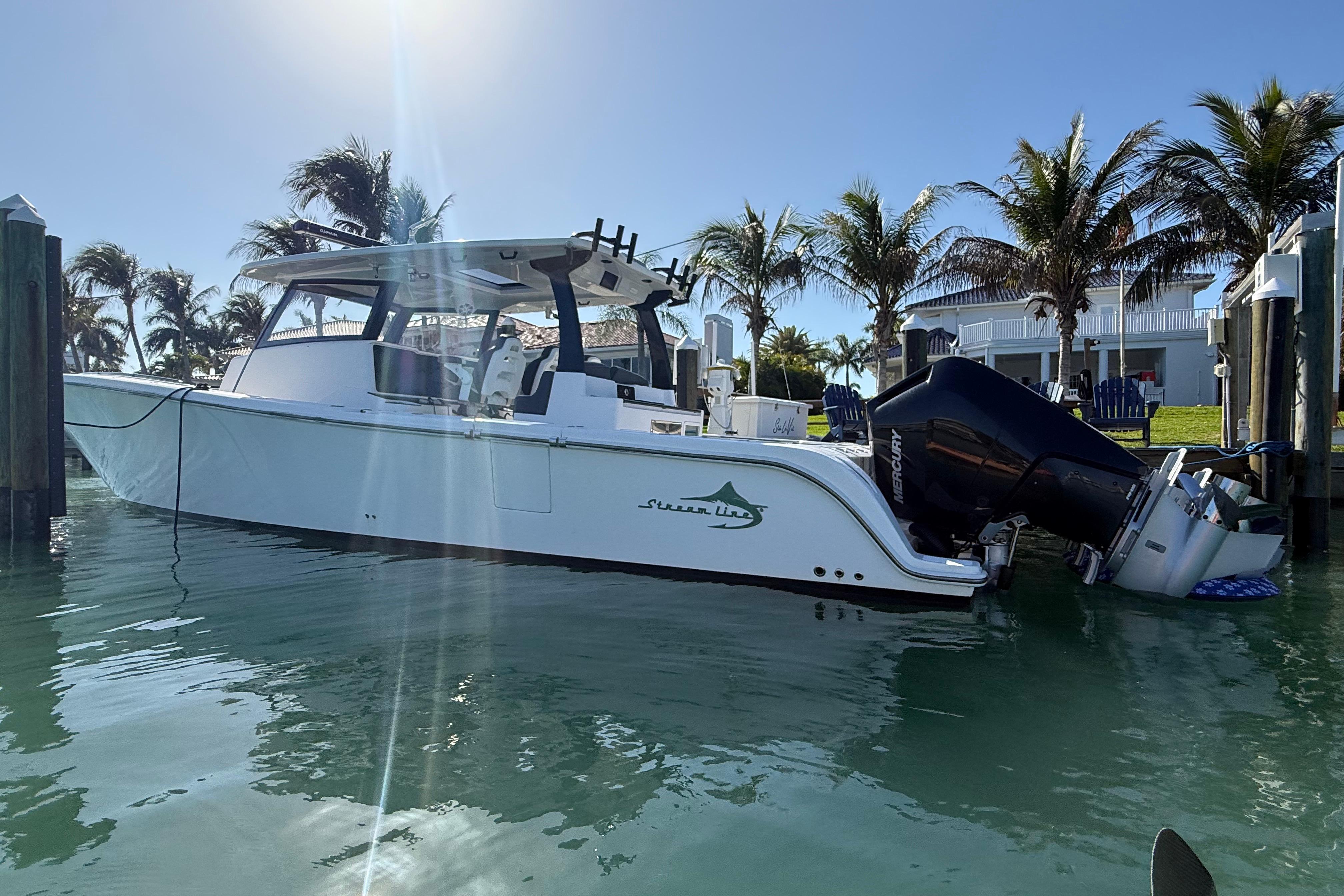 2020 Streamline 45 boat docked in sunny marina with palm trees.