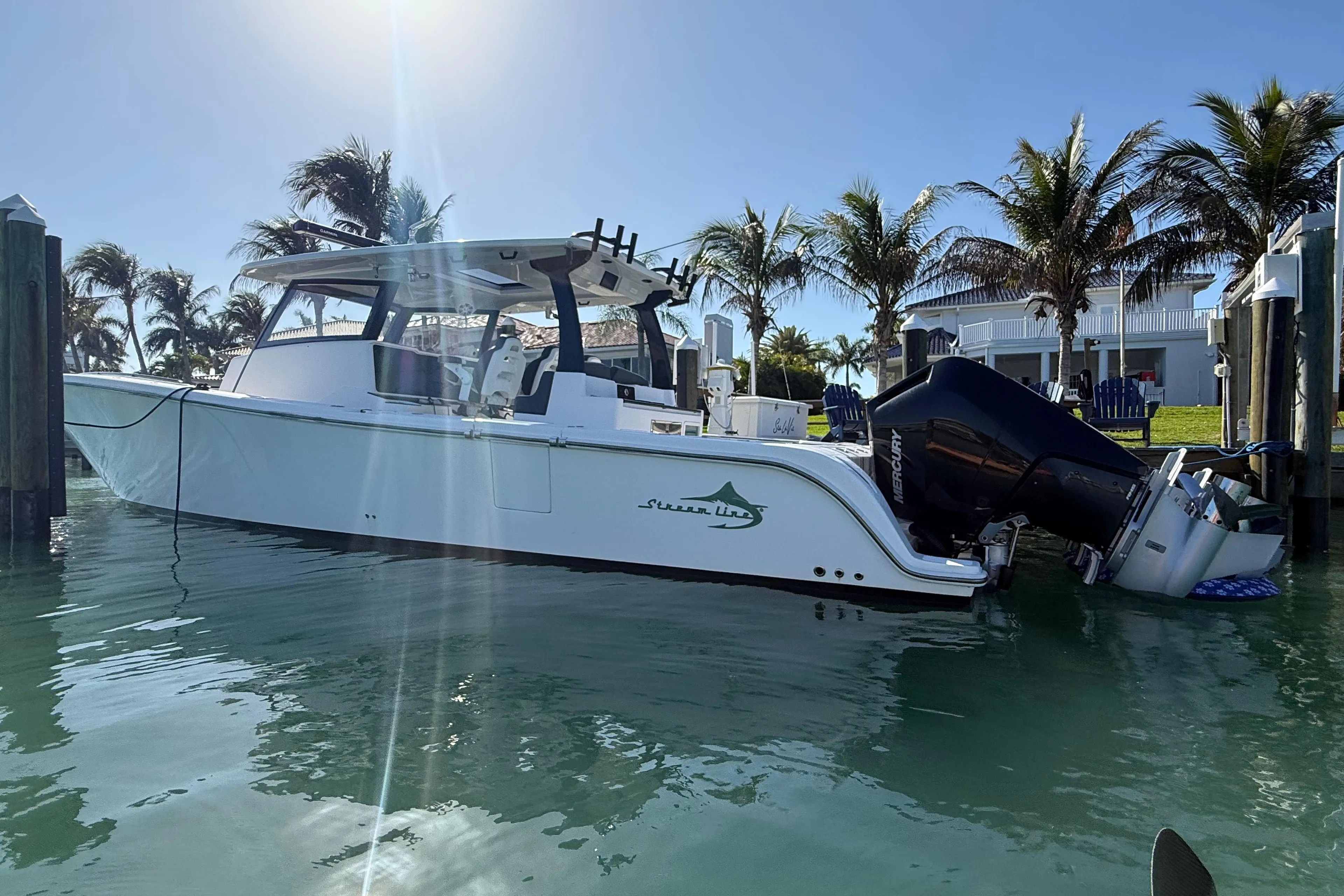 2020 Streamline 45 boat docked in sunny marina with palm trees.