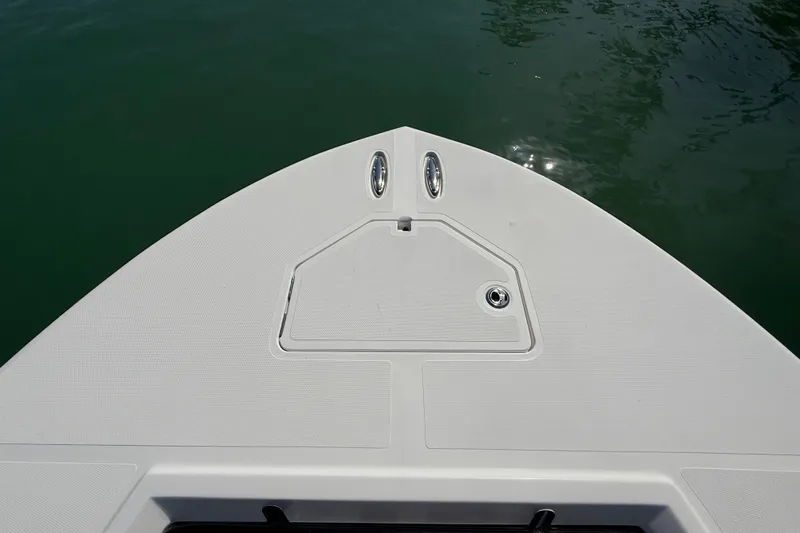  Yacht Photos Pics Bow of 2020 Streamline 45 boat on calm water, featuring sleek design and storage hatch.