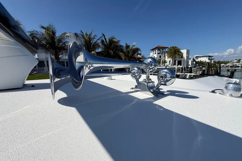  Yacht Photos Pics Chrome boat horn on 2020 Streamline 45 yacht, docked near palm trees and luxury homes.