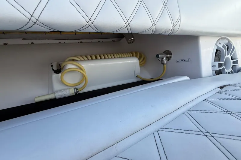  Yacht Photos Pics Interior of 2020 Streamline 45 boat with white quilted seating and coiled hose.