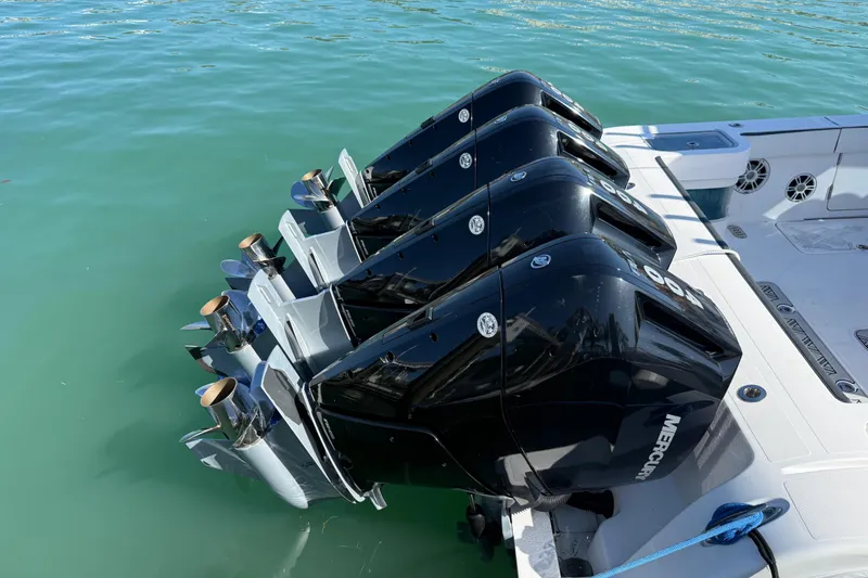  Yacht Photos Pics Four powerful outboard motors on a 2020 Streamline 45 boat in clear water.