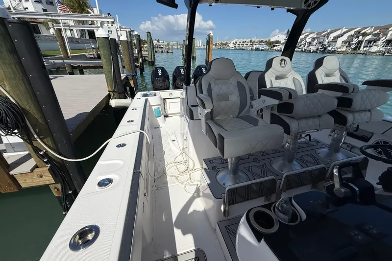  Yacht Photos Pics Luxurious 2020 Streamline 45 boat interior with plush seating, docked by clear blue water.