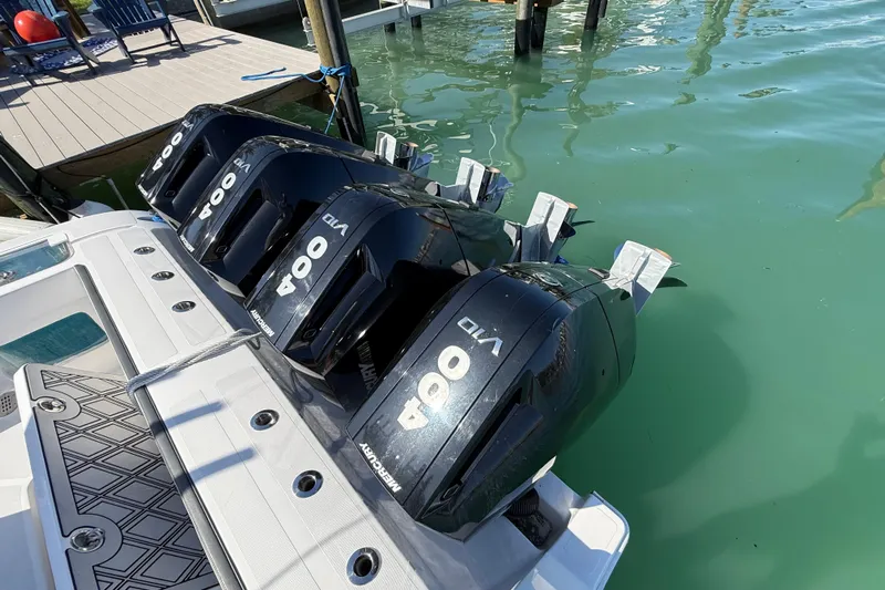  Yacht Photos Pics Four powerful outboard motors on a 2020 Streamline 45 boat docked in clear water.