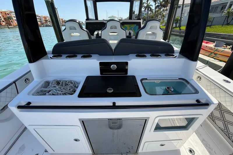  Yacht Photos Pics Streamline 45 boat interior with seating, storage, and control panel, docked by the water.