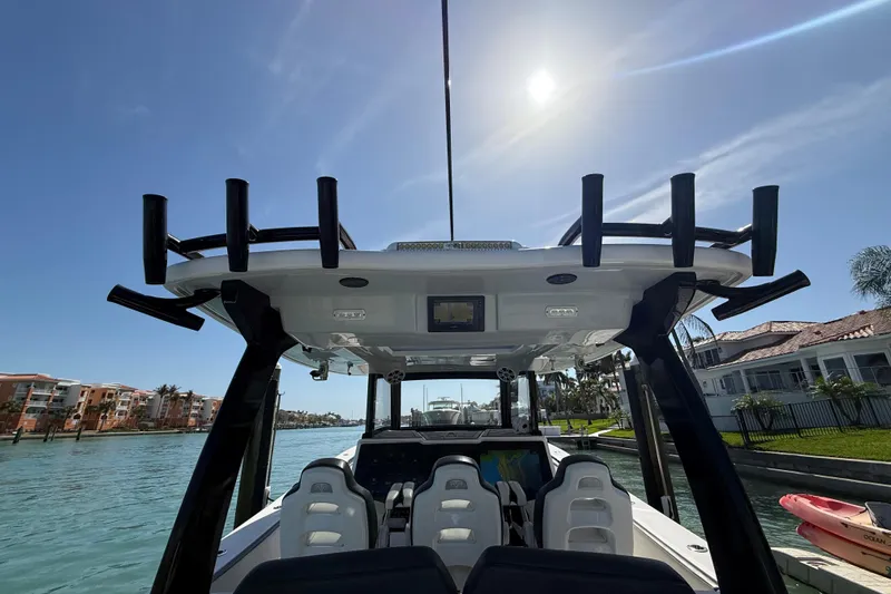  Yacht Photos Pics Streamline 45 boat interior, 2020 model, with rod holders, under sunny sky near waterfront homes.