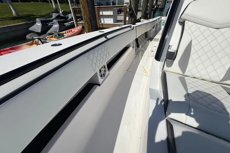 Yacht Photos Pics 2020 Streamline 45 boat interior with white quilted seats and speaker detail.