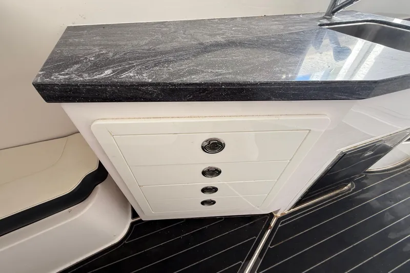  Yacht Photos Pics Streamline 45 boat interior with sleek black countertop and white drawers, 2020 model.