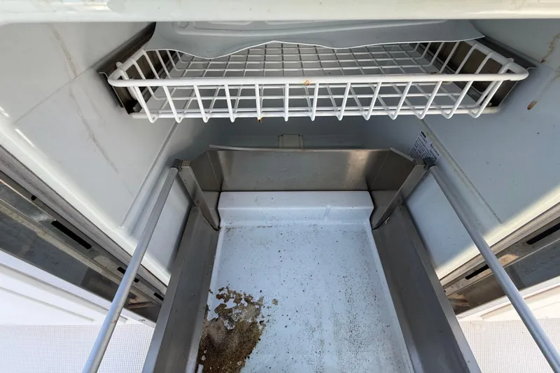  Yacht Photos Pics Open Streamline 45 freezer interior, showing empty wire shelf and bottom tray, 2020 model.