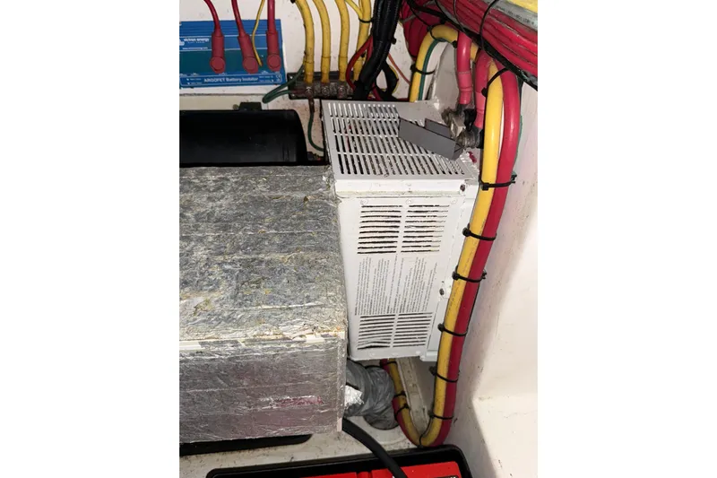  Yacht Photos Pics Electrical wiring and components inside a 2020 Streamline 45, featuring colorful cables and a battery isolator.