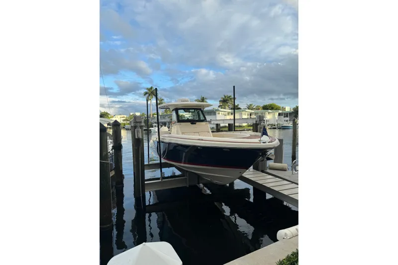 Para-dice Yacht Photos Pics 2023 Chris-Craft Catalina 30 docked at marina under cloudy sky.
