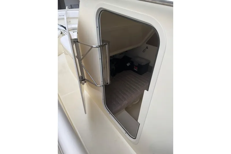 Para-dice Yacht Photos Pics 2023 Chris-Craft Catalina 30 cabin interior with open hatch and visible storage.