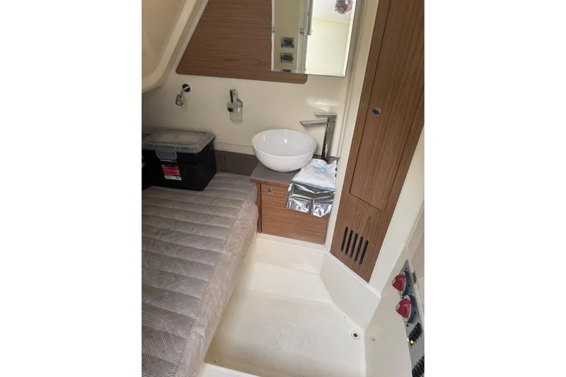 Para-dice Yacht Photos Pics 2023 Chris-Craft Catalina 30 interior cabin with bed, sink, and storage.