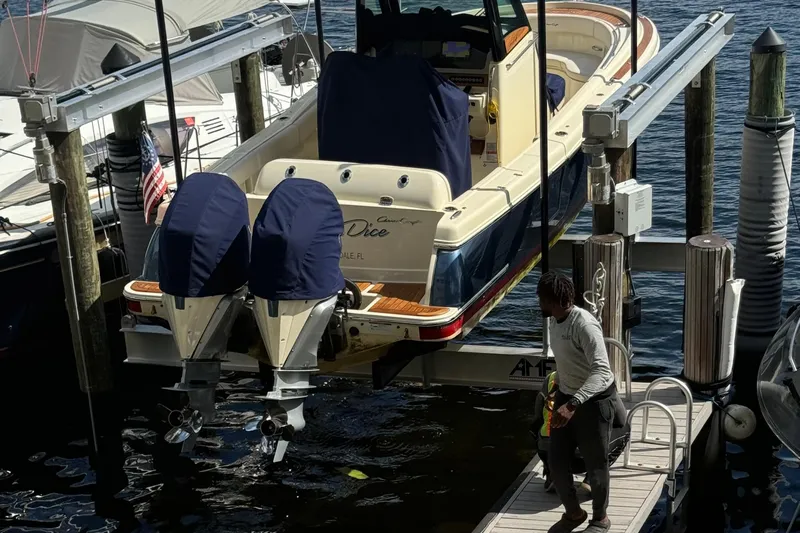 Para-dice Yacht Photos Pics 2023 Chris-Craft Catalina 30 boat docked with dual engines, person on pier nearby.