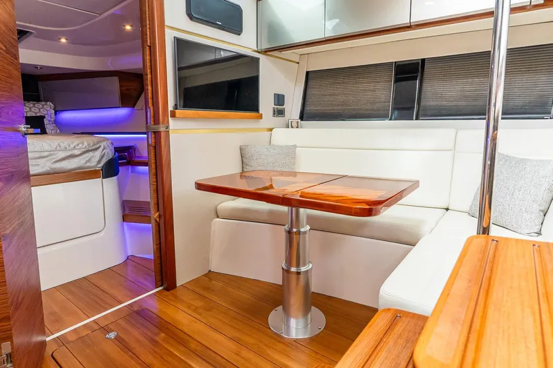  Yacht Photos Pics 2024 Boston Whaler 405 Conquest interior with elegant seating and wooden table.