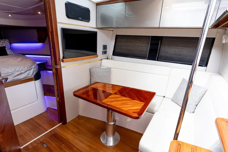  Yacht Photos Pics 2024 Boston Whaler 405 Conquest interior with elegant seating and wooden table.