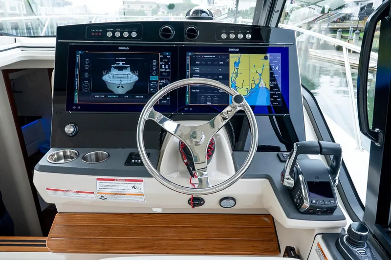  Yacht Photos Pics 2024 Boston Whaler 405 Conquest helm with dual Simrad displays and modern controls.