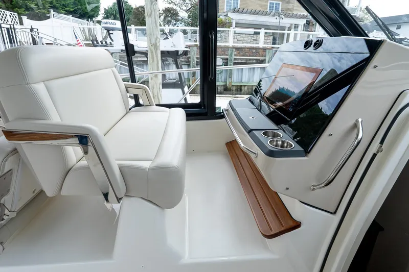  Yacht Photos Pics 2024 Boston Whaler 405 Conquest helm with luxurious seating and modern controls.