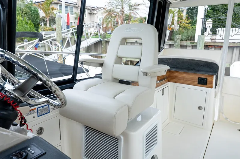  Yacht Photos Pics 2024 Boston Whaler 405 Conquest helm with luxurious seating and modern controls.