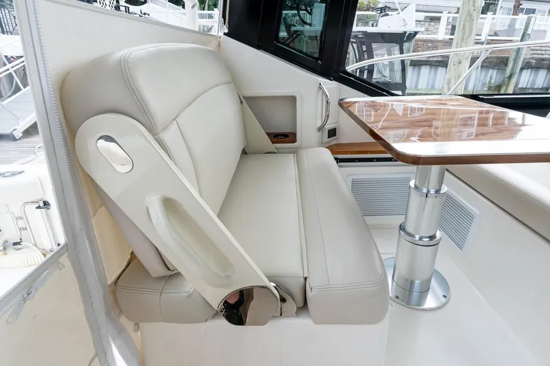  Yacht Photos Pics 2024 Boston Whaler 405 Conquest interior with beige seating and wooden table.