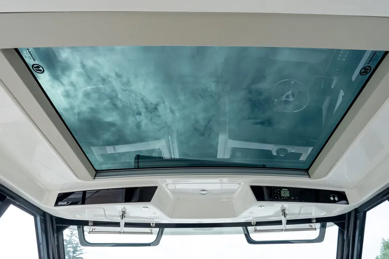  Yacht Photos Pics 2024 Boston Whaler 405 Conquest glass roof showcasing sky view.