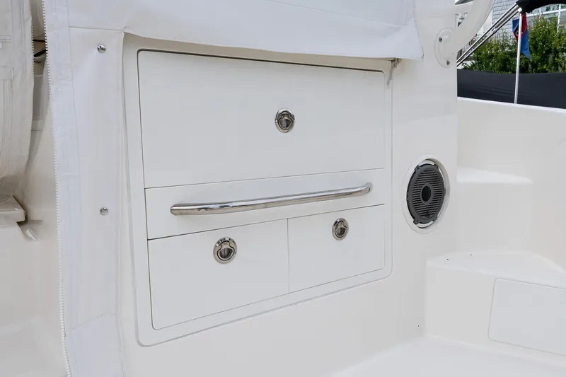  Yacht Photos Pics 2024 Boston Whaler 405 Conquest storage compartment with sleek design and integrated speaker.