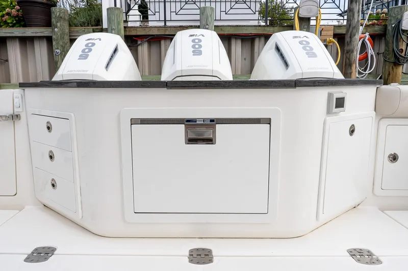  Yacht Photos Pics 2024 Boston Whaler 405 Conquest boat with triple outboard engines and storage compartments.