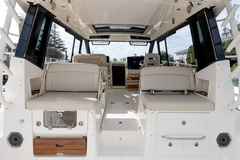  Yacht Photos Pics 2024 Boston Whaler 405 Conquest interior with beige seating and modern design.