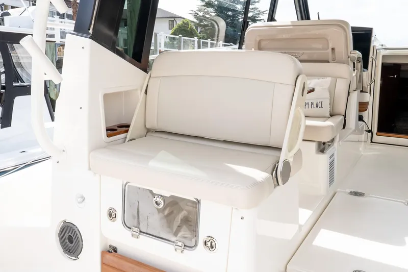  Yacht Photos Pics 2024 Boston Whaler 405 Conquest interior seating area with modern design and amenities.