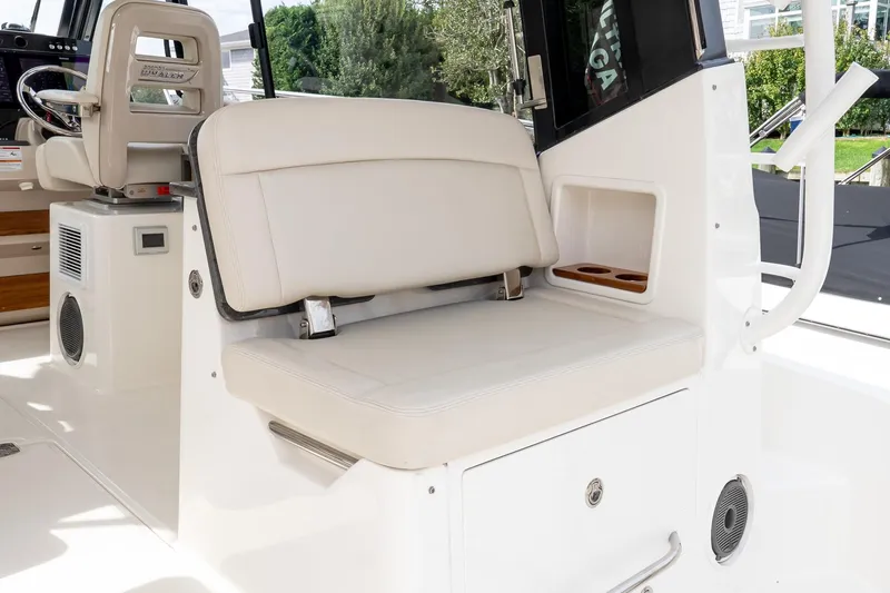  Yacht Photos Pics 2024 Boston Whaler 405 Conquest interior seating with storage and cup holders.
