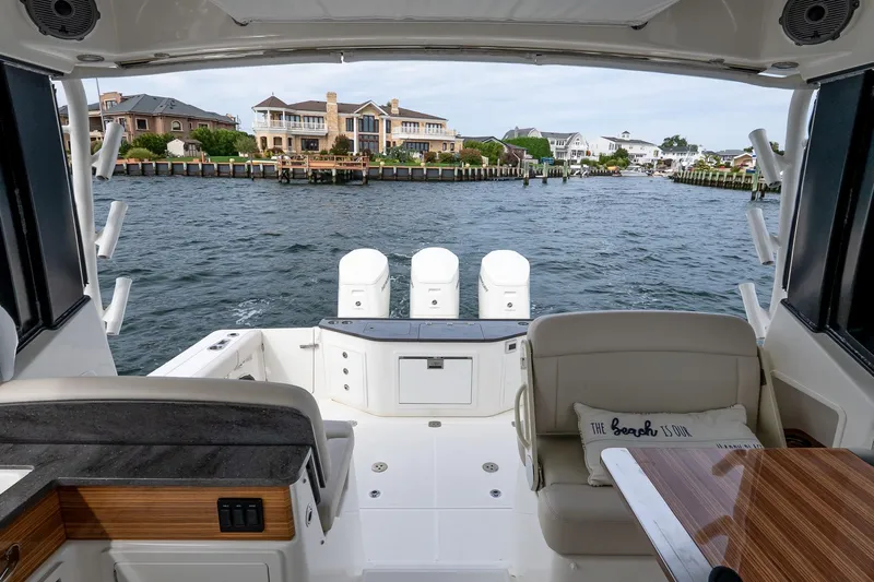  Yacht Photos Pics 2024 Boston Whaler 405 Conquest boat interior with waterfront view and luxurious seating.
