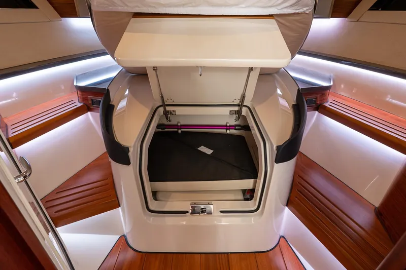  Yacht Photos Pics 2024 Boston Whaler 405 Conquest cabin interior with storage compartment open.