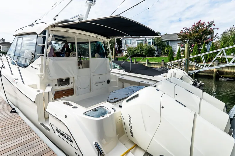  Yacht Photos Pics 2024 Boston Whaler 405 Conquest docked, showcasing sleek design and powerful Mercury engines.