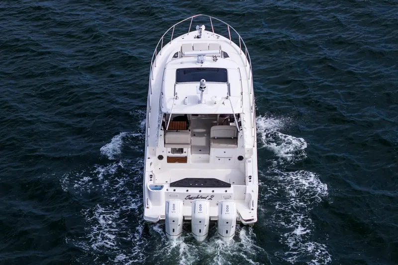  Yacht Photos Pics 2024 Boston Whaler 405 Conquest cruising on open water, rear view.
