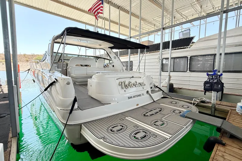 Notorious Yacht Photos Pics 2003 Sea Ray 460 Sundancer yacht docked in a marina, rear view with American flag.