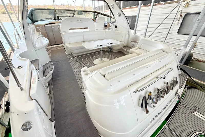 Notorious Yacht Photos Pics 2003 Sea Ray 460 Sundancer yacht interior with white seating and table, docked in marina.